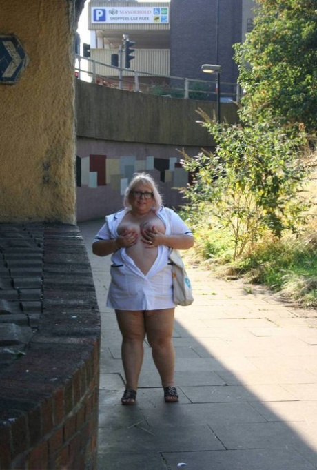 Lexie Cummings, a fat and elderly nurse, takes on weight while walking on the sidewalk.