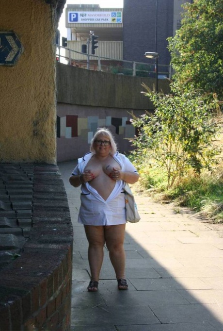 Senior nurse Lexie Cummings, who is fat and older than her peers, bares herself on the sidewalk as she walks.