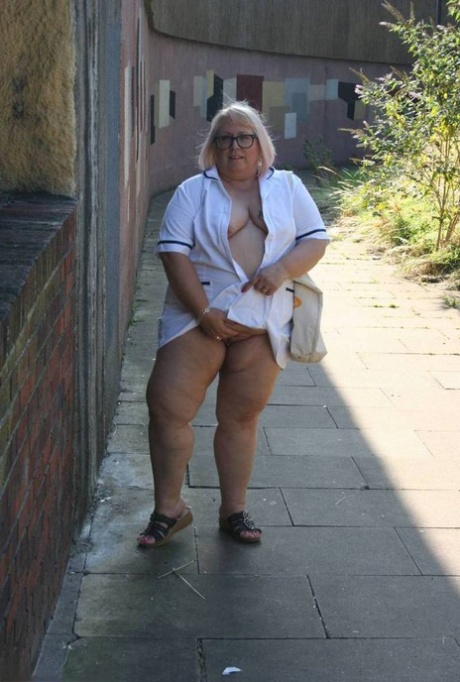 On the sidewalk, Lexie Cummings exposes herself due to her age and being an elderly nurse who is overweight.