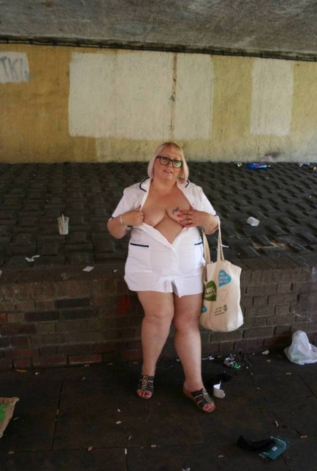 While walking on the street, Lexie Cummings a fat and older nurse puts her clothes down over her head.