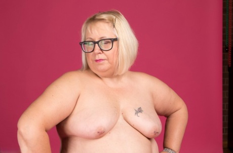 Dressed in stockings and glasses, blonde Lexie Cummings is not required to wear tops as she has a fat body.