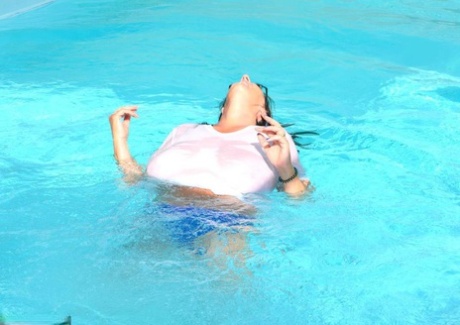 During a swimming competition, Lu Lu Lush from Britain releases her wet T-shirt and produces enormous tits.