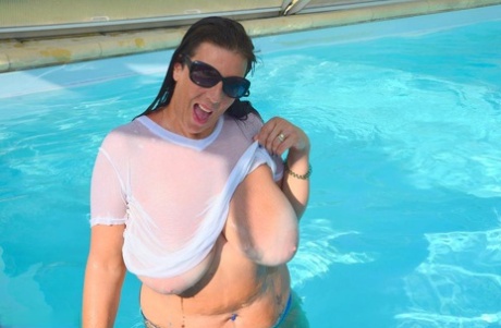 Lu Lu Lush, a British amusement park performer, releases her large t-shirt and wetsuits into a swimming pool.