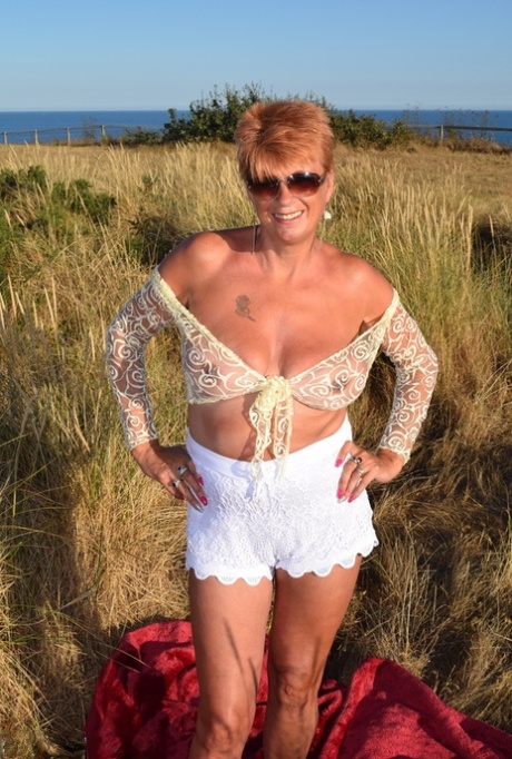 Despite the weather, Dimonty's fit and experienced older partner uncovers large natural phenomena on top of a blanket that overlooks the ocean.
