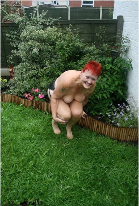 An example of a naked granny with red hair is Valgasmic Exposed, who poses in the yard with nylons on her body.