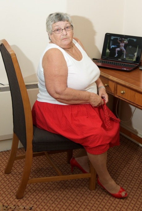 Naked in tan trousers, the Obese granny Dirty Doctor watches XXX action unfold on screen.