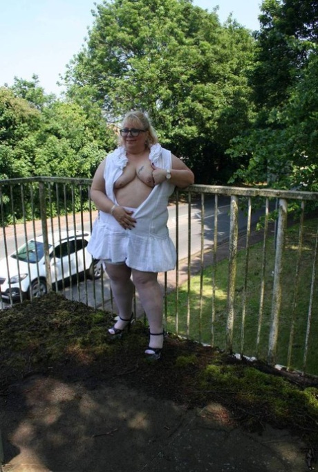 Lexie Cummings, a fat blonde, exposes herself while crossing a pedestrian overpass.