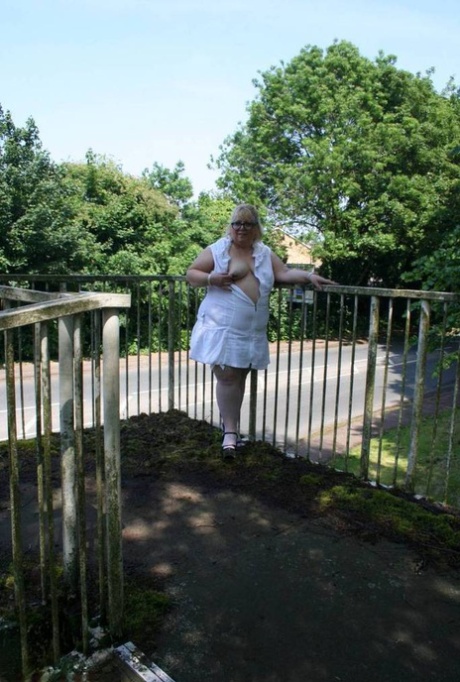 Lexie Cummings, a plump blonde woman, exposes herself while crossing a pedestrian overpass.