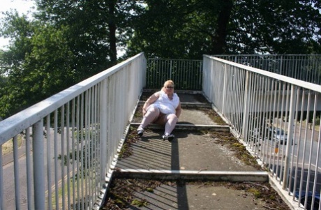 Overpassing: Lexie Cummings, who is fat and blonde at the time, shows off her body as she crosses a pedestrian overpass.