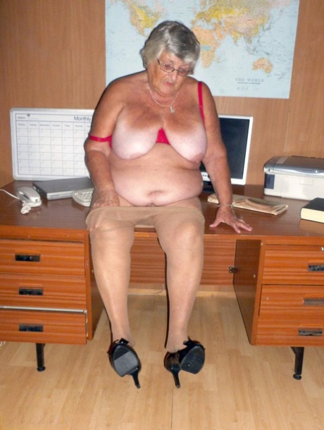 In her tuxedo, Grandma Libby (an Obsessed British citizen) is stripped down to her nude on a computer desk.