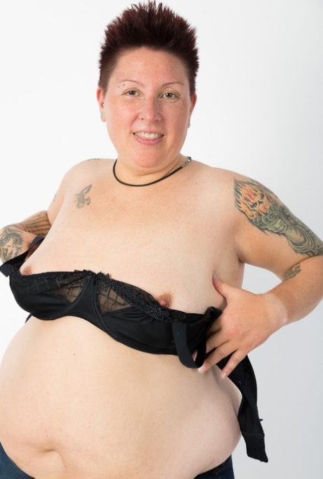 A solitary tattoo artist who is overweight exposes herself solely to her shoes and socks.