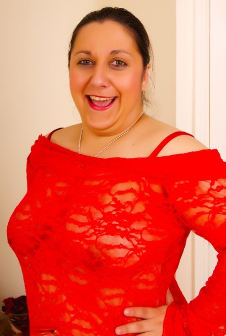Modest waist: Kimberly Scott, an amateur plumper, removes her natural tits from the top of a red dress.