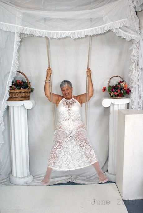 Short Haired Oma Savana Models All White Lingerie And Hosiery On A Swing