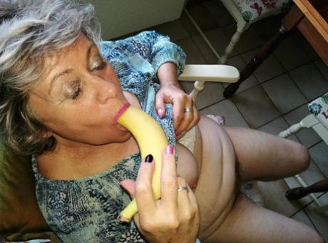 Inside her normal pussy area, Horny granny Caro keeps a banana in the comfort of her kitchen chair.