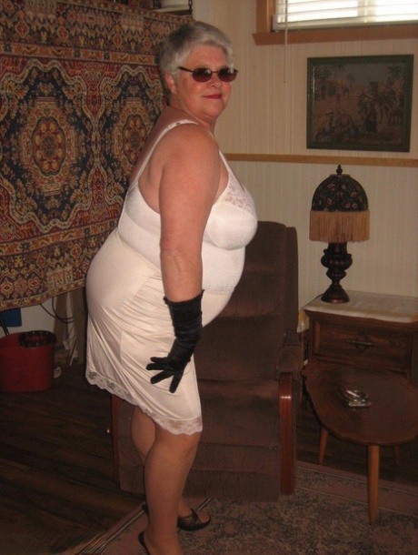 The fat girdle goddess exposes herself in shades, gloves, and pantyhose.