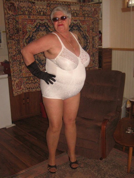 She is dressed as a fat granny, Girdle Goddess in her most nude outfit, including shades, gloves and pantyhose.