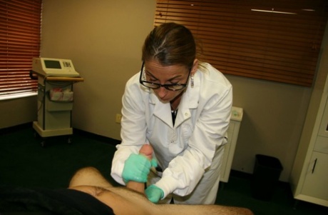 A lab technician wearing latex gloves tugs and pulls a dick.