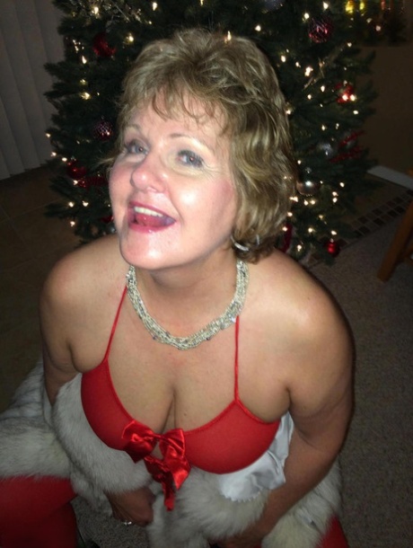 Busty Bliss, a self-confessed elderly man, performs oral sex during the Christmas festivities while unveiling lingerie.