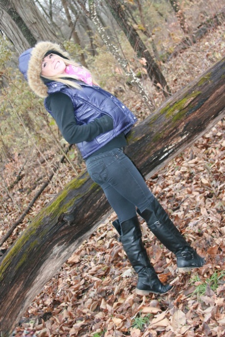 A pink bra is worn by amateur girl Meet Madden while hiking in the woods on a cold day.