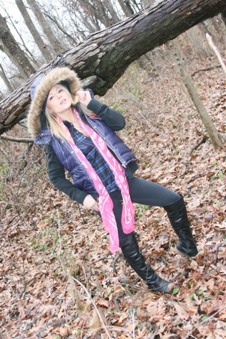 In the woods on a cold day, amateur girl Meet Madden flaunts her pink bra.