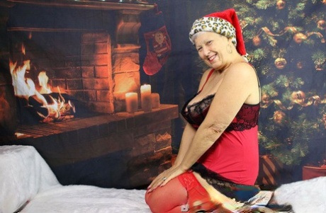 Horny Grandmother Produces A Dildo After Baring Her Huge Tits At Christmas
