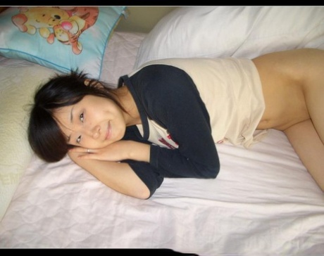 In bed naked, the petite Asian girlfriend exposes her balding partner.