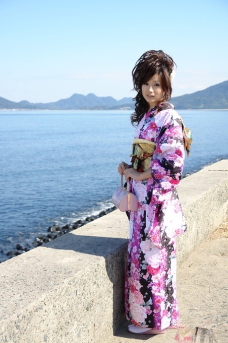 Chiaki, an Asian model wearing a kimono, walks along the beach and surrounding area.