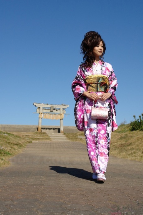 A young Asian model named Chiaki walks along the beach and surrounding area in a kimono.