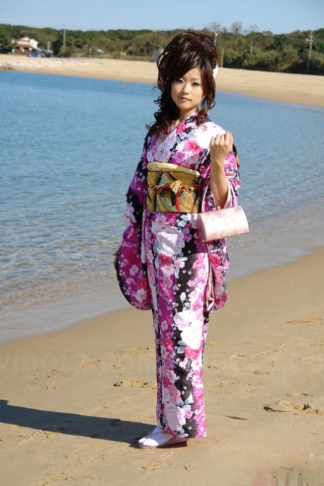 Wearing a kimono, Chiaki, an Asian model, walks by the beach and surrounding area.