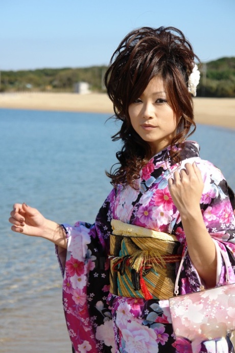 A kimono-clad Asian model named Chiaki walks along the beach and surrounding area.