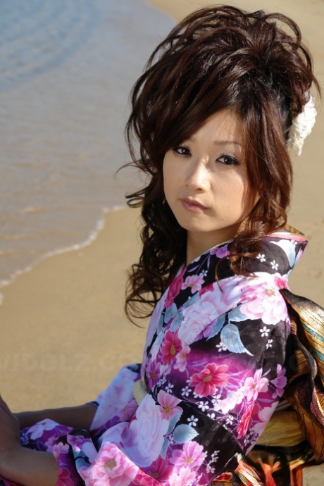 Dressed in a bikino, Asian model Chiaki strolls along the beach and surrounding area.