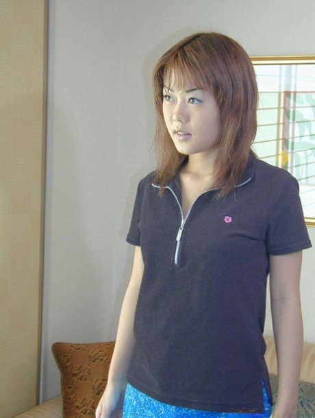 A young Asian girl displays her pink bush for the first time.