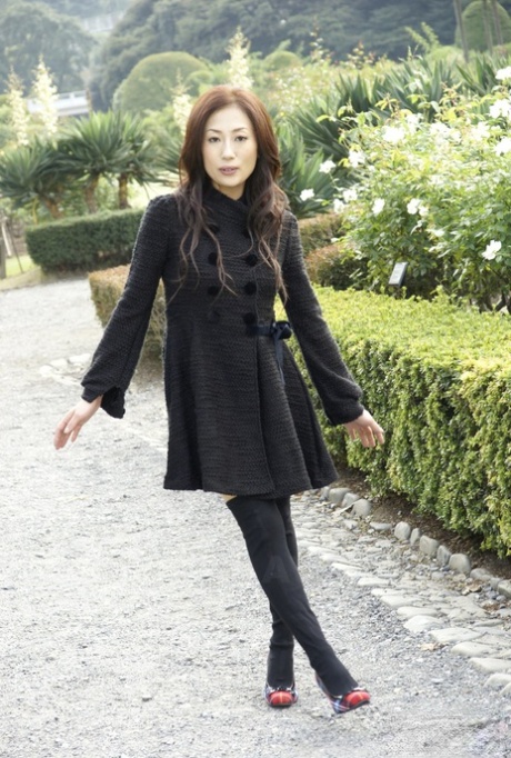 Fully clothed Japanese teen models in the park in black clothes and stockings