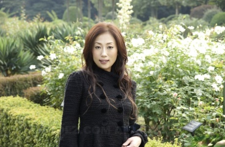 Fully clothed Japanese teen models in the park in black clothes and stockings