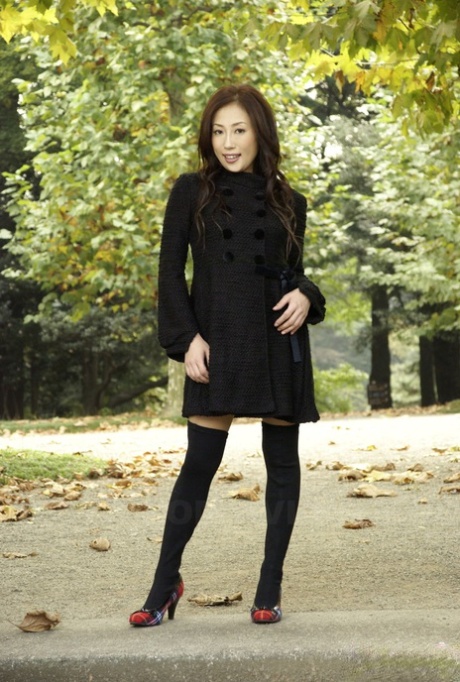 Fully clothed Japanese teen models in the park in black clothes and stockings