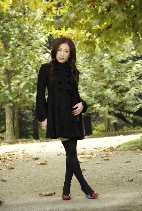 Fully clothed Japanese teen models in the park in black clothes and stockings