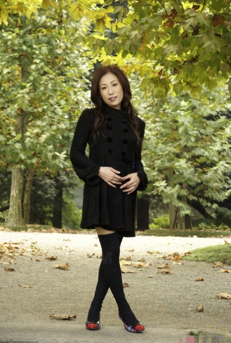 Fully clothed Japanese teen models in the park in black clothes and stockings