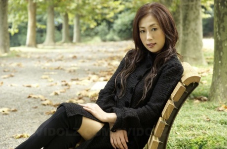 Fully clothed Japanese teen models in the park in black clothes and stockings