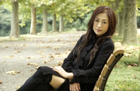 Fully clothed Japanese teen models in the park in black clothes and stockings