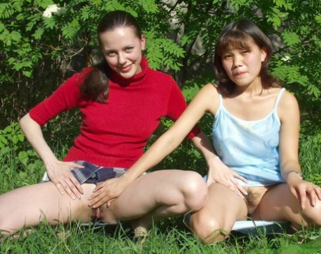 A group of lesbian amateurs strut around in the middle of a park and then lick their pussies with their fists and asses.