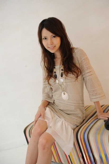 Rino Tokiwa, a single Japanese female model wearing skirt and ankle strap shoes while in the buff.