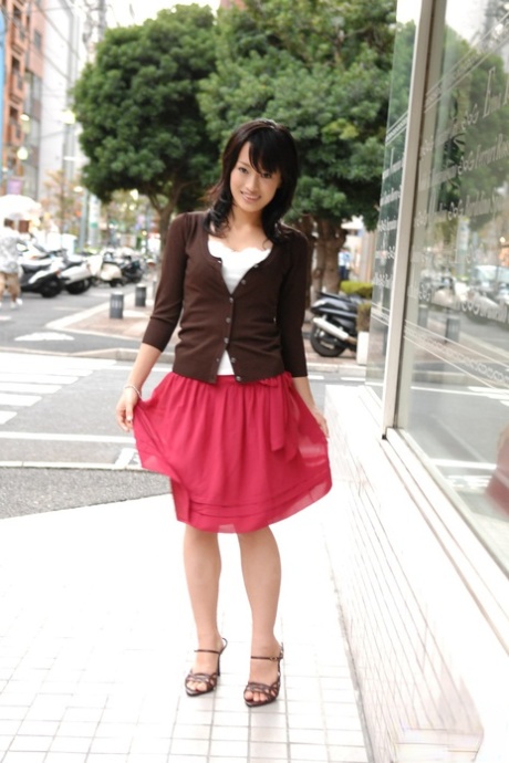 A knee-length skirt by Japanese beauty Mio Kanna is seen walking downtown.