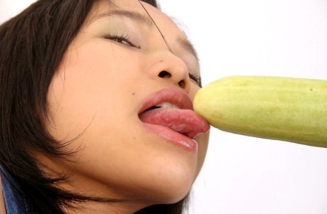 Girls in Asia wear pretty socks while an Asian solo girl enjoys satisfying vegetable filling on her genitals.