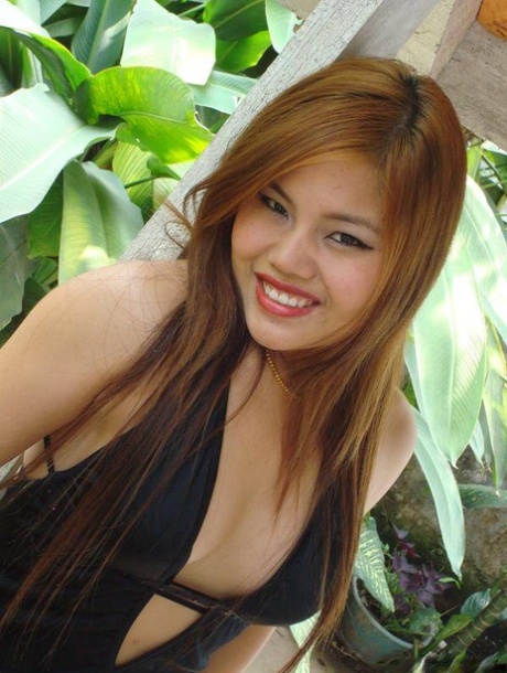 A Filipino woman in a black dress exposes her exposed legs while modeling non-nude clothing.