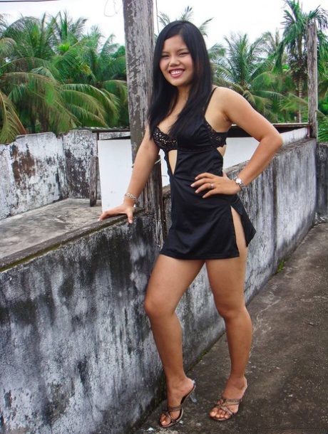 During the modeling of non-nude poses, an unclothed Filipino girl in a black dress displays her legs.