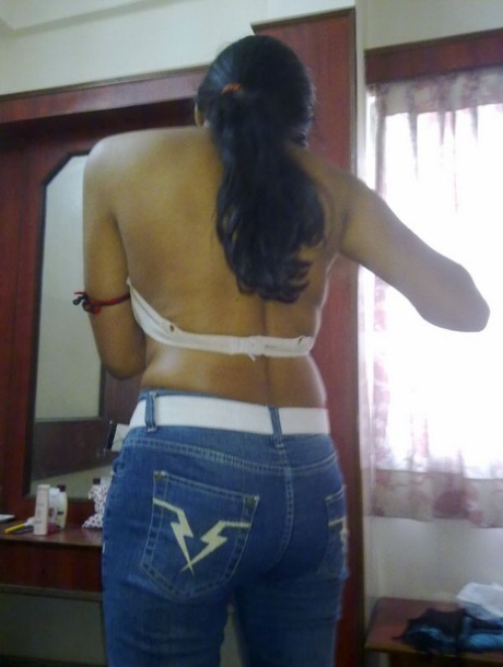 MILF, an Indian woman who wears blue jeans, displays her natural tits.