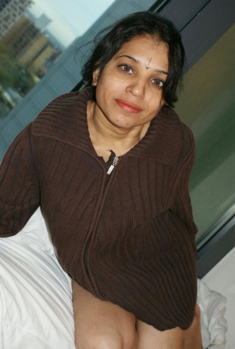 Unfolded: Indian woman Kavya Sharma releases her natural tits from the sweater.