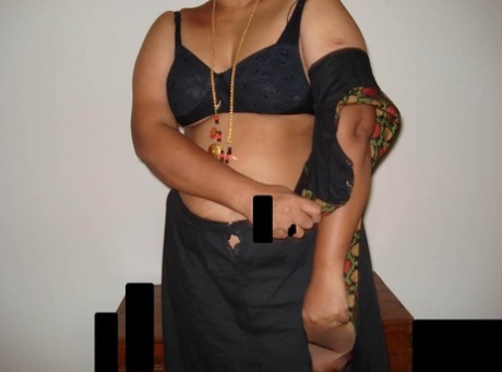 Following the act of stripping off her clothes, an overweight Indian woman sits down and takes a seat.
