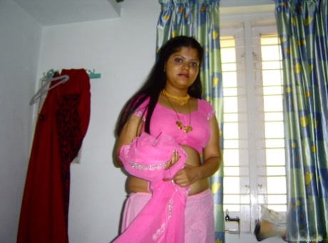 One action: Plump Indian girl Neha gets completely naked on her bed.