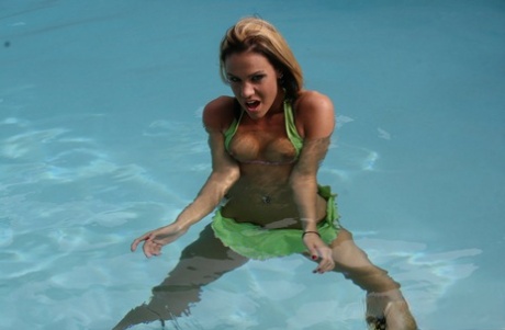 In a pool, Addison St James, an amateur girl, releases her little legs from a bikini top.